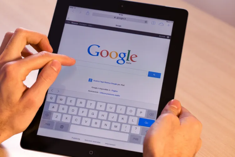 image of finger pointing on a tablet and the google search bar