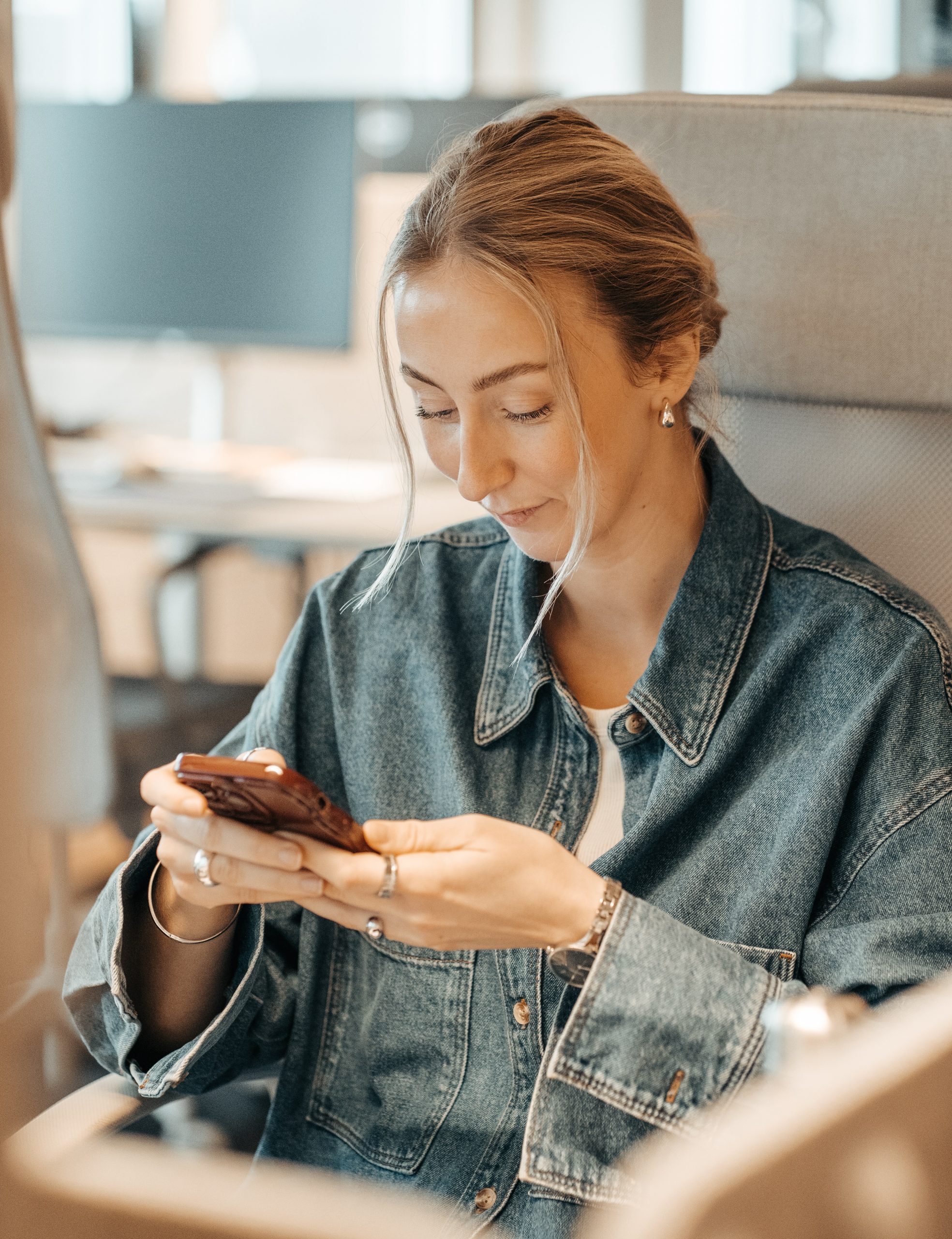 En tjej sitter med sin mobil